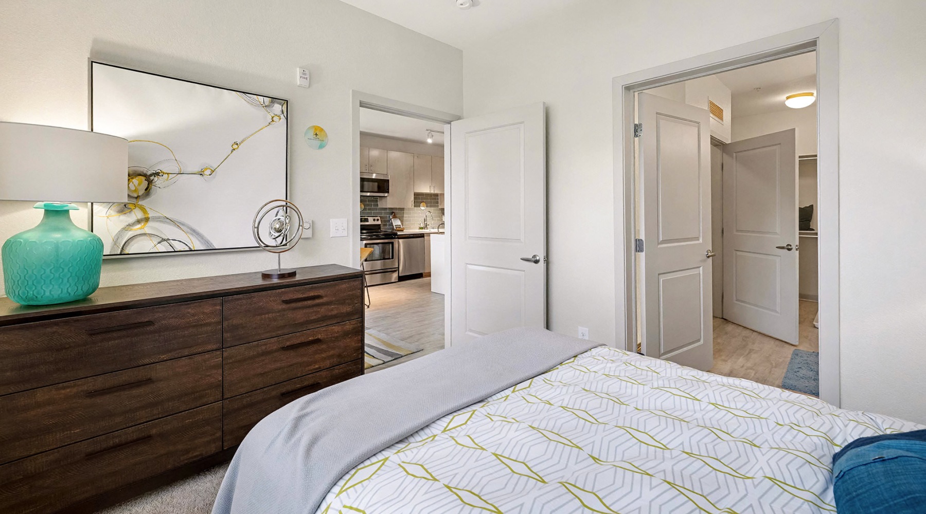 a bedroom with a bed and a dresser