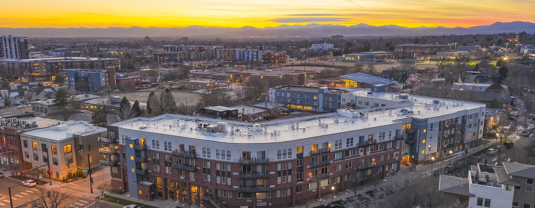 a city with buildings and a sunset
